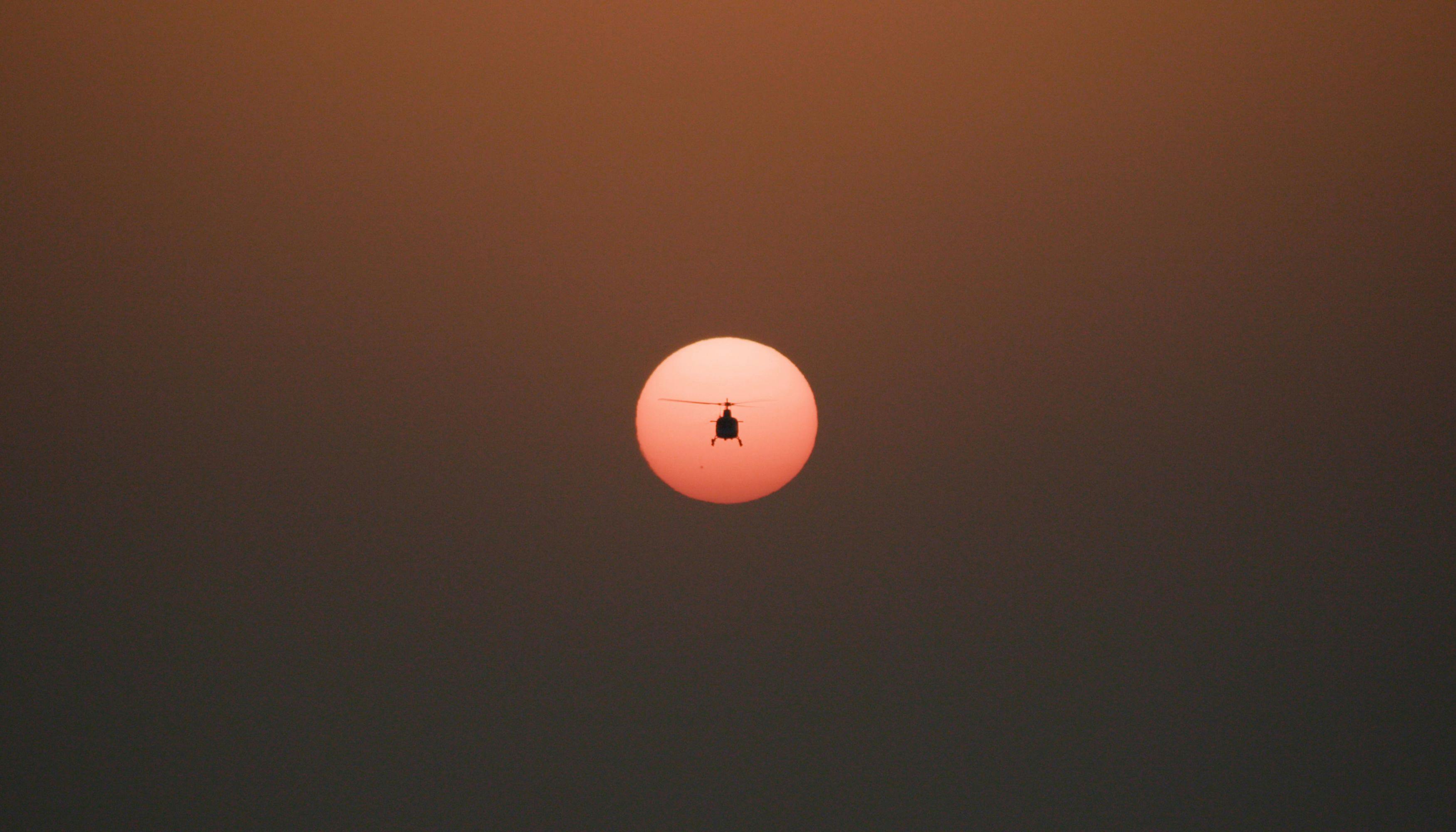 A helicopter against the sun